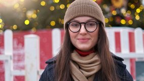 Outdoor close up portrait of young beautiful happy smiling girl with red lips, wearing french style beret, posing in street of european city. Winter fashion, Christmas holidays concept. Copy space