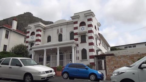 05.12.18: HD cloudy summer day video of Muizenberg suburb small town, Hebrew Congregation historical 1926 Jewish Synagogue at the Atlantic Ocean coast in Western Cape near Cape Town, South Africa