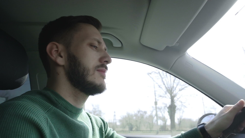 Successful businessman is driving a car