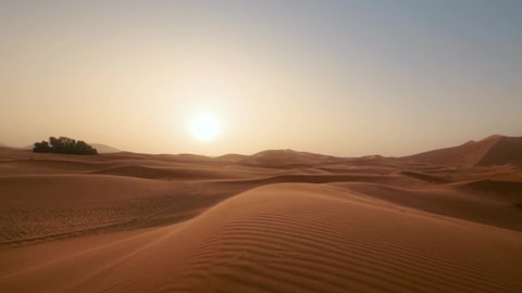 golder sand close up Sahara desert. Sunset. Sand dunes and blue sky. Beautiful desert landscape. Sahara desert. Sand dunes Arabian desert. Sand dunes wave pattern. Nature background, morocco