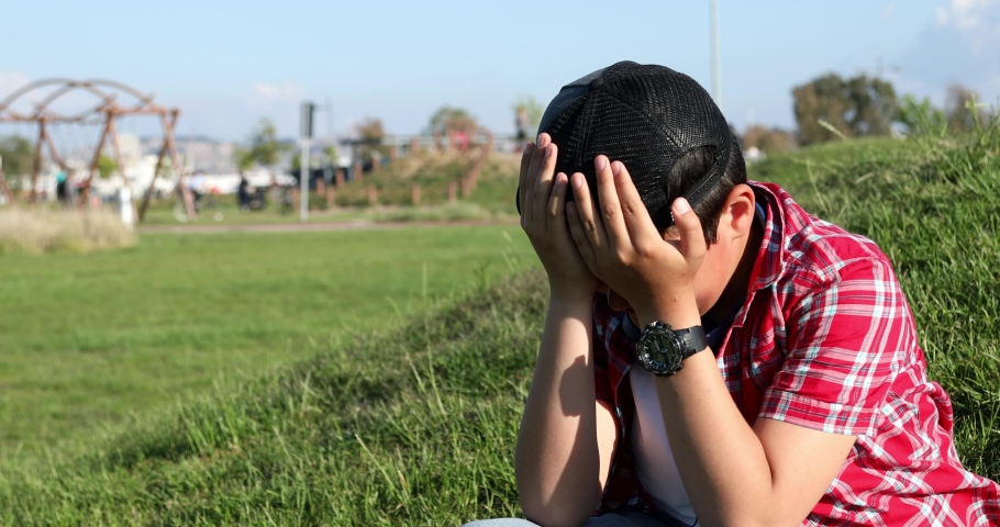 Sad preteen boy crying at the park alone Royalty-Free Stock Footage #1030155392