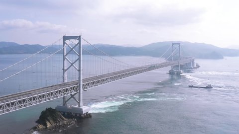 Japan, Naruto Bridge and whirlpools, aerial view by drone