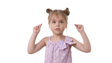 Video portrait of a little girl snapping fingers isolated over white background. Studio video shot of child emotions in 4K definition.