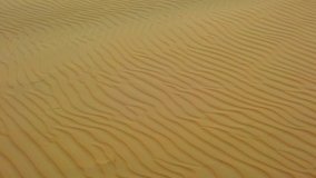 HD slow motion video of top view on sand dunes in Sahara desert, Africa. There are beautiful waves on the sand.