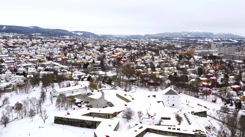 Trondheim, Norway. Aerial view of the city center in winter in Trondheim, Norway with heavy snow. River and historical colorful buildings, Trondheim Castle