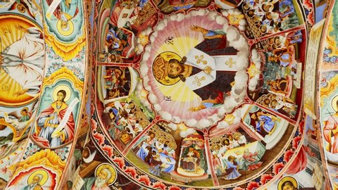 Interior of Rila Monastery - the largest and most famous Eastern Orthodox monastery in Bulgaria. Ceiling paintings, frescoes, biblical stories in pictures 4k