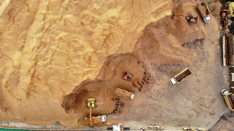 Aerial top view of wood chips with backhoe working loading chip to truck concept green fuel for save earth..