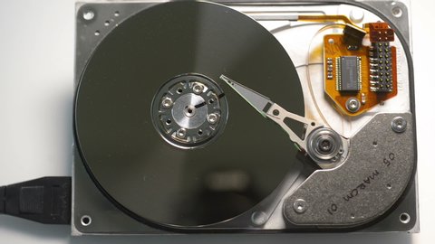 Disassembled hdd reading head. Hard disk drive initialization.