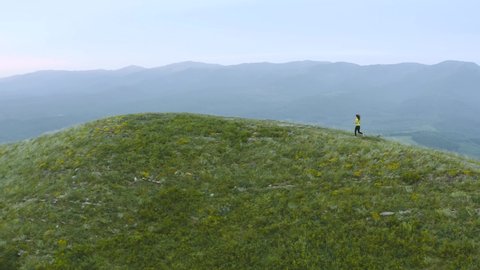 Young Female Runner Training in the Mountains, Aerial Shot.