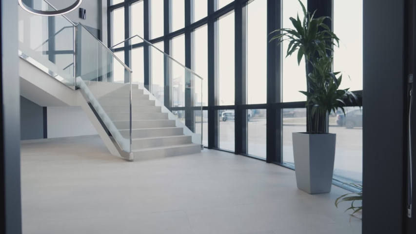 Modern staircase in business center lobby. glass railing. Royalty-Free Stock Footage #1030207136