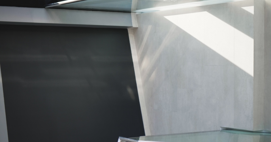 Top view of young man in formalwear with coffee cup and briefcase walking downstairs. vertical screen, vertical video