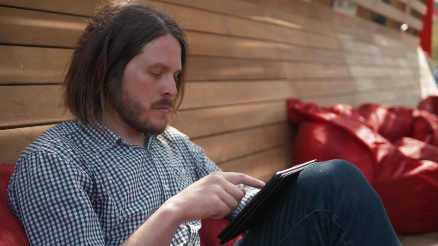 young handsome fashion model businessmen using tablet outdoors, man male portrait with tablet in city work