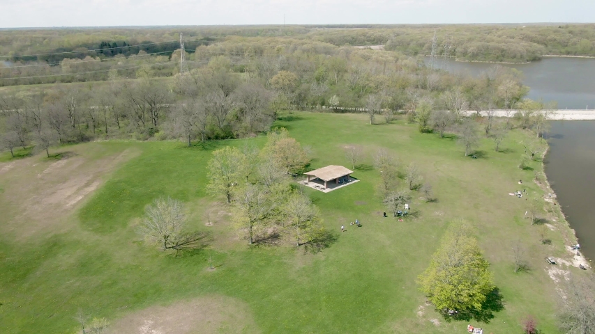 Aerial circular motion around a pavilion in a public park near a lake. Tampier Slough Woods in the western suburbs of Chicago, Illinois, near Lemont.