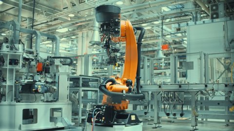 Time Lapse Robotic Arm Assembles Parts for a Car.