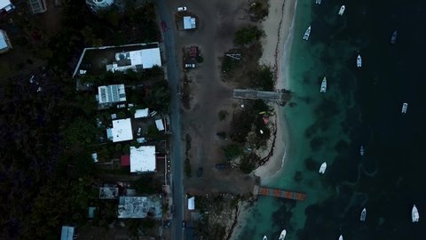 View of the bay of the small town of Esmeralda located in Vieques Puerto Rico during sunset and dusk with beautiful vivid colors among boats, islands, and coast.