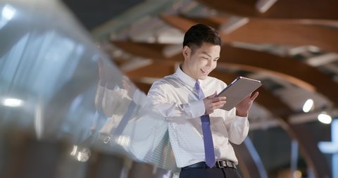 businessman use the tablet outdoor in the evening