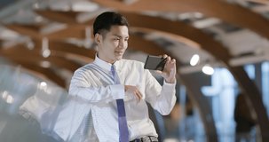 businessman watch the video with phone outdoor