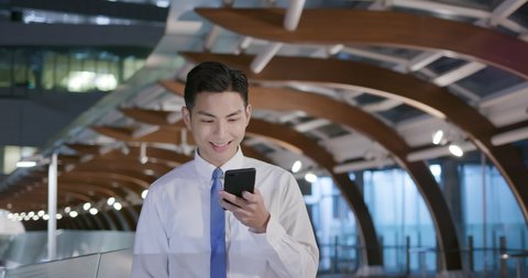 young businessman use the smart phone while walking