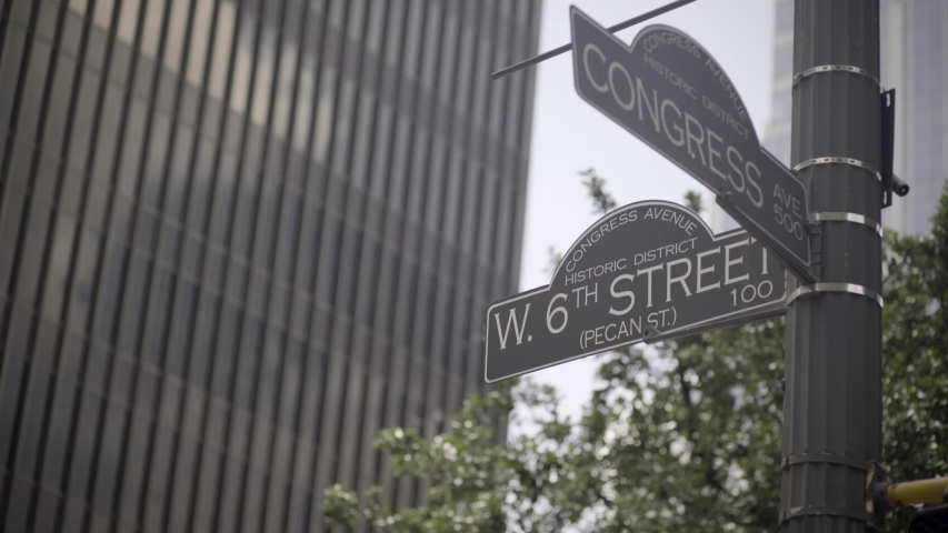 The street signs for 6th street and Congress avenue in Austin, Texas - slight camera movement