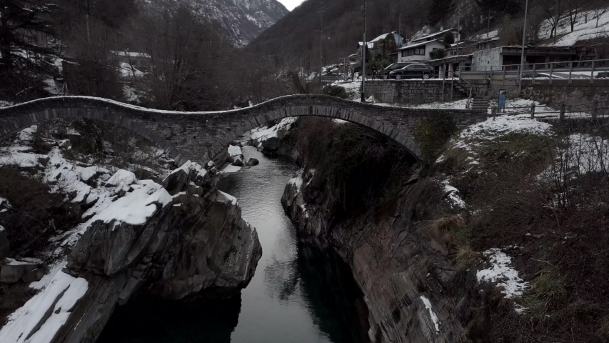 Cinematic aerial view at Lavertezzo, Switzerland in winter season. Lavertezzo is a small village with a valley and mountains along the river Verzasca in the Swiss canton Ticino.