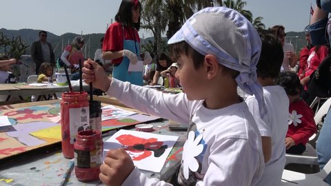 Gocek, Turkey - 23d of April 2019: 4K Celebration of the Child day in Turkey - Children are painting at the street workshop near marina
