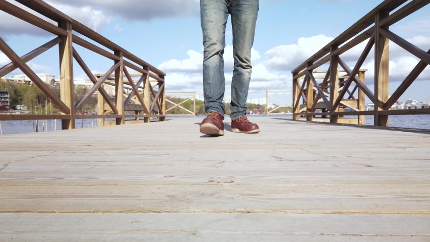 Detail / Cluse up footage of man walking towards camera and stop right in front of the lens