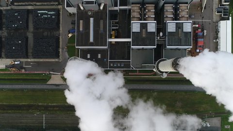 Aerial top down view of coal fired power station is a thermal plant which burns a fossil fuel to produce electricity by converting heat of combustion into mechanical energy 4k high resolution