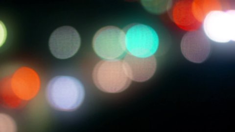 Abstract blurred and bokeh image of city lights from the train window at night.