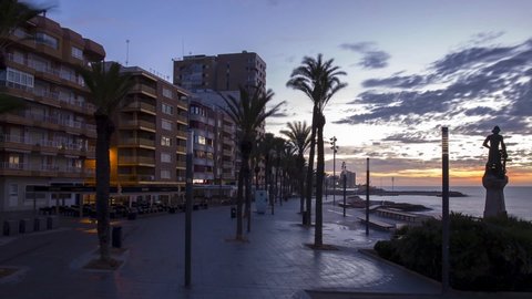 3/10/2018, Torrevieja, Spain, 7.21 a.m., The promenade of Torrevieja in Spain in the early morning. People are on the move and the sun is rising. Time lapse Video. 