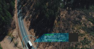 Helicopter shot of self Driving trucks driving on a forest highway with technology assistant tracking information, showing details. Visual effects clip
