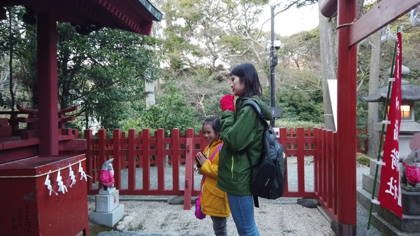 Tokyo, Japan: 21 March 2019: Mother and Daughter is praying in Kamakura shrine.
