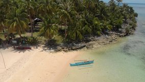 Drone flying out from the beach on Siargao Island in the Philippines and around a palm tree jungle