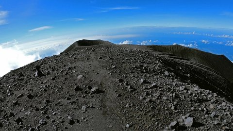 Climbing the crater of Semeru. Backpacker walking around Semeru crater on the top of mountain. POV shot first person veiw on breathtaking panorama from a height of 3,600 meters
