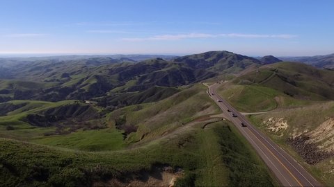 Drone shot overlooking the countryside off of Highway 41 as cars drive along the road
