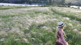 Beautiful girl in dress and hat on the field in the setting sun. - Powered by Shutterstock - Get 15% off with code: PIKWIZARD15