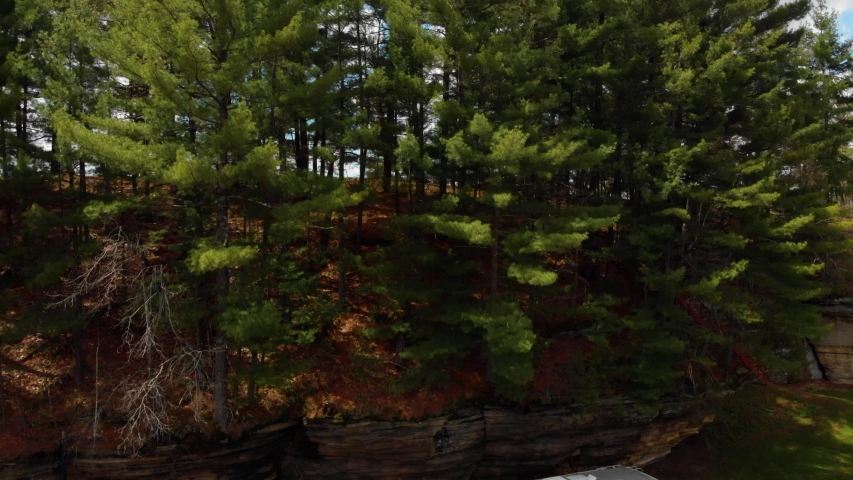 Reveal of Wisconsin countryside over a rockface at a county park