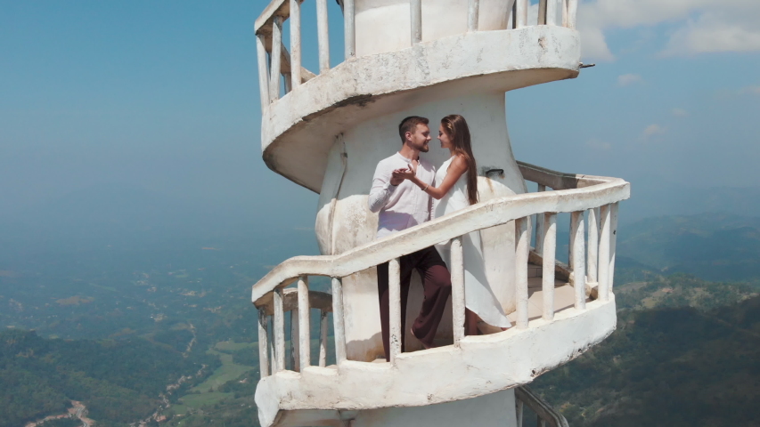 Aerial view of couple in love hugging on a Tower