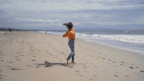 Happy barefoot girl on the beach