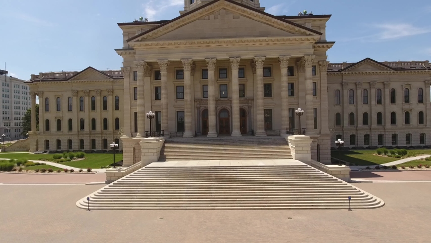 Flying up the north entrance to the capitol building in Topeka Ks on a sunny spring day. Awesome view of the front steps, columns, tower, copper dome, and Ad Astra statue.