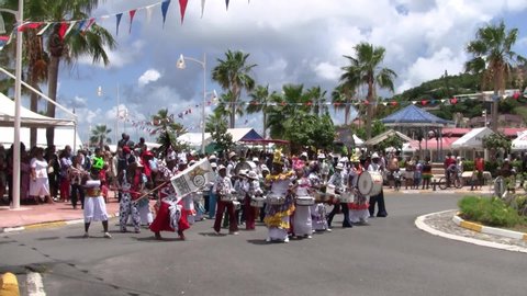 Marigot, Saint Martin - Circa July 2013: Parade for July 14th, the French National holiday with creole bands marching in the streets of Marigot, the capital of the French part of Saint Martin.