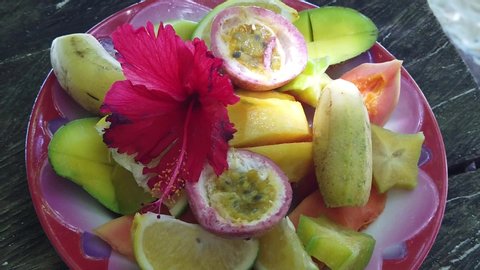 SLOW MOTION: fresh local fruit dish at Anse Source d'Argent, La Digue. Healthy exotic summer diet on tropical beach at Seychelles.