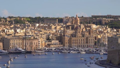 VALLETTA, MALTA - NOVEMBER 12, 2018 - The coastline of Isla Birgu island with harbour, cruise ship, boats and panorama of the city in 4k