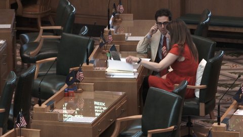SALEM, OREGON / USA - MAY 2019: Young lawmakers stay late going over details from metting in the House of Representatives.