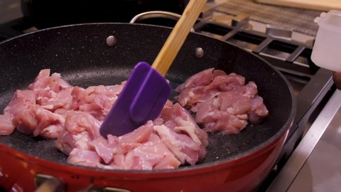 Chicken being cooked in a frying pan
