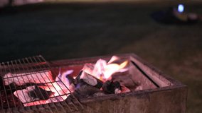 Glowing barbecue embers, fire charcoal in stove for cooking and grilling food or outdoors barbecue. Royalty high-quality free stock footage of embers burning with red and yellow flame