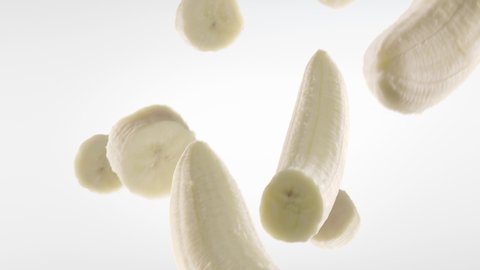 Banana with Slices Falling on White Background. Loopable