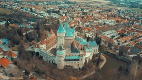Aerial View beautiful landscape on Bojnice castle in city, mountains background in summer sunny day with blue sky, Drone 4K Video