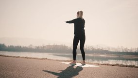 Young woman doing sports workout. 4K slow motion video. Woman running walking in outdoors park on sunny day, close-up legs sport shoes. Female exercising in the gym