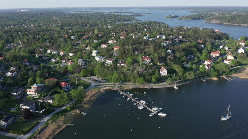 Luxurious exclusive waterfront homes in Stockholm Djursholm Danderyd. Aerial drone shot high angle view of most expensive houses Royalty-Free Stock Footage #1030386845