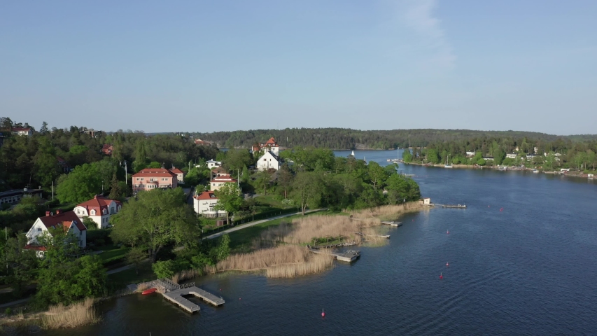 Exclusive waterfront homes in Stockholm Danderyd Djursholm . Aerial drone shot of most expensive mansion by the sea in  Swedish archipelago Royalty-Free Stock Footage #1030387160
